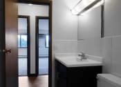 Thumbnail 31 of 56 - a bathroom with a toilet sink and mirror