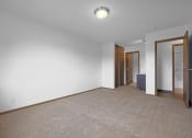 Thumbnail 38 of 56 - a bedroom with white walls and a carpeted floor