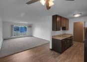 Thumbnail 20 of 56 - an empty living room and dining room with a ceiling fan