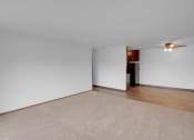 Thumbnail 23 of 56 - a bedroom with white walls and a beige rug