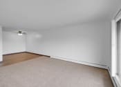 Thumbnail 22 of 56 - a bedroom with white walls and a ceiling fan