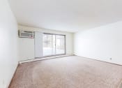Thumbnail 15 of 56 - a bedroom with a sliding glass door and a carpeted floor