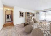 Thumbnail 9 of 56 - a living room with white walls and a large window