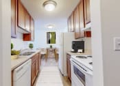 Thumbnail 7 of 56 - a kitchen with white appliances and wooden cabinets