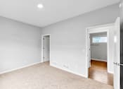 Thumbnail 10 of 47 - A room with white walls and a carpeted floor.