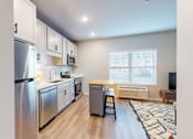 Thumbnail 58 of 67 - A modern kitchen with stainless steel appliances and wooden flooring.
