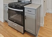 Thumbnail 21 of 48 - a kitchen with stainless steel appliances and white cabinets at Foxtail Hollow Townhomes, Minnesota, 55449