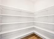 Thumbnail 7 of 15 - Empty white shelves in a room.