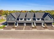 Thumbnail 32 of 48 - an aerial view of a house with three garage doors at Foxtail Hollow Townhomes, Blaine, MN