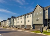 Thumbnail 35 of 48 - a row of houses on the side of a street at Foxtail Hollow Townhomes, Blaine, 55449