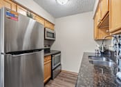 Thumbnail 7 of 15 - Modern Kitchen at Granite Peaks Apartments, Minnesota