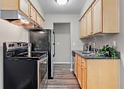 Thumbnail 7 of 21 - Contemporary Kitchen at Granite Ridge Apartments, Brooklyn Park, Minnesota
