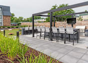 Thumbnail 5 of 40 - a patio with a table and chairs and a television