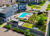 Thumbnail 40 of 40 - A pool surrounded by a grassy area and a building.