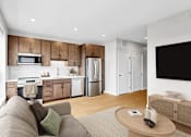 Thumbnail 103 of 110 - A modern kitchen with wooden cabinets and a grey sofa.
