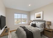Thumbnail 32 of 52 - A bedroom with a large bed, a flat screen TV, and a window overlooking a balcony.