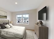 Thumbnail 31 of 52 - A bedroom with a large bed and a flat screen TV mounted on the wall.