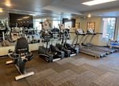 Thumbnail 25 of 35 - Fitness center with cardio machines at Aspenwood Apartments, MN, 55123