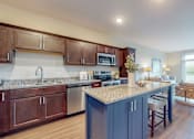 Thumbnail 27 of 82 - a kitchen with a large island and a living room in the background  at Lake Jonathan Flats, Minnesota