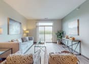 Thumbnail 31 of 82 - a living room with a sliding glass door leading to a balconyat Lake Jonathan Flats, Chaska, MN