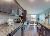 Thumbnail 29 of 82 - a kitchen with granite countertops and stainless steel appliances at Lake Jonathan Flats, Minnesota, 55318