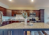 Thumbnail 28 of 82 - a kitchen with a large island and a living room in the background at Lake Jonathan Flats, Minnesota