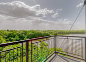 Thumbnail 24 of 82 - A balcony with a metal railing overlooks a lush green landscape. at Lake Jonathan Flats, Minnesota