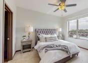 Thumbnail 18 of 82 - A bedroom with a large bed and a ceiling fan. at Lake Jonathan Flats, Chaska, MN, 55318