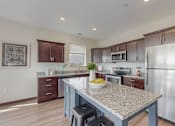 Thumbnail 11 of 82 - A kitchen with a granite countertop and stainless steel appliances. at Lake Jonathan Flats, Chaska, MN