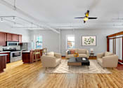 Thumbnail 2 of 24 - A living room with a brown sofa and a coffee table.