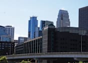 Thumbnail 55 of 55 - A cityscape with a bridge in the foreground and tall buildings in the background.