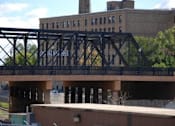 Thumbnail 51 of 55 - A bridge with a metal railing and a sign that says "HAL W. AOUS".