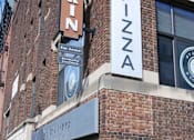 Thumbnail 47 of 55 - A brick building with a sign that says "RINZA" and "For Lease" on it.