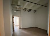 Thumbnail 37 of 44 - A long, empty hallway with a door at the end.at Gurley Lofts, Minneapolis, MN 55401