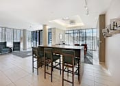 Thumbnail 46 of 73 - A modern dining room with a bar stool style table and chairs.at Third North Apartments, Minnesota, 55401