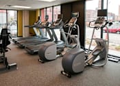 Thumbnail 57 of 73 - A gym with treadmills and elliptical machines.at Third North Apartments, Minneapolis