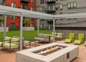 Thumbnail 6 of 73 - A patio with a fire pit and chairs.at Third North Apartments, Minneapolis, MN 