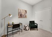 Thumbnail 10 of 77 - A room with a desk, chair, and painting on the wall.at Viridium Apartments, Minnesota 