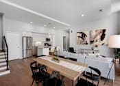 Thumbnail 2 of 77 - A modern kitchen with a dining table and chairs.at Viridium Apartments, Minneapolis, MN 55401 
