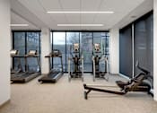 Thumbnail 36 of 77 - A gym with treadmills, elliptical machines, and a stationary bike.at Viridium Apartments, Minneapolis, 55401 