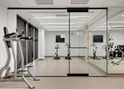 Thumbnail 38 of 77 - A gym with treadmills and exercise bikes.at Viridium Apartments, Minnesota 