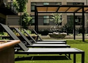 Thumbnail 50 of 77 - A modern outdoor seating area with a bench and a table.at Viridium Apartments, Minneapolis 