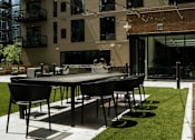 Thumbnail 51 of 77 - A black table and chairs are set up on a patio.at Viridium Apartments, Minneapolis, 55401 