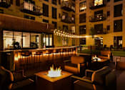 Thumbnail 69 of 77 - A patio with a fire pit and chairs.at Viridium Apartments, Minnesota 