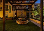 Thumbnail 71 of 77 - A modern outdoor seating area with a hanging chair.at Viridium Apartments, Minneapolis, MN 