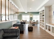 Thumbnail 10 of 80 - Grey sofa with dinning table and chairs at The Barnum Apartments, Minnesota