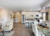 Thumbnail 26 of 80 - A modern kitchen with a dining table and chairs at The Barnum Apartments, MN, 55110