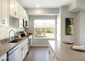 Thumbnail 29 of 80 - A kitchen with white cabinets at The Barnum Apartments, Minnesota