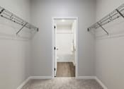 Thumbnail 35 of 80 - A white door is open to a hallway with a carpeted floor at The Barnum Apartments, White Bear Lake, MN,  55110