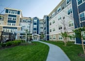 Thumbnail 3 of 80 - Building Entrance road at The Barnum Apartments, MN, 55110